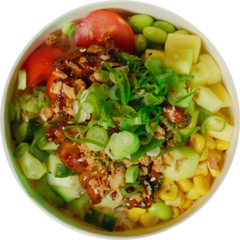 A chicken poké bowl with mango, corn, cucumber, tomato and edamame, seen from straight above